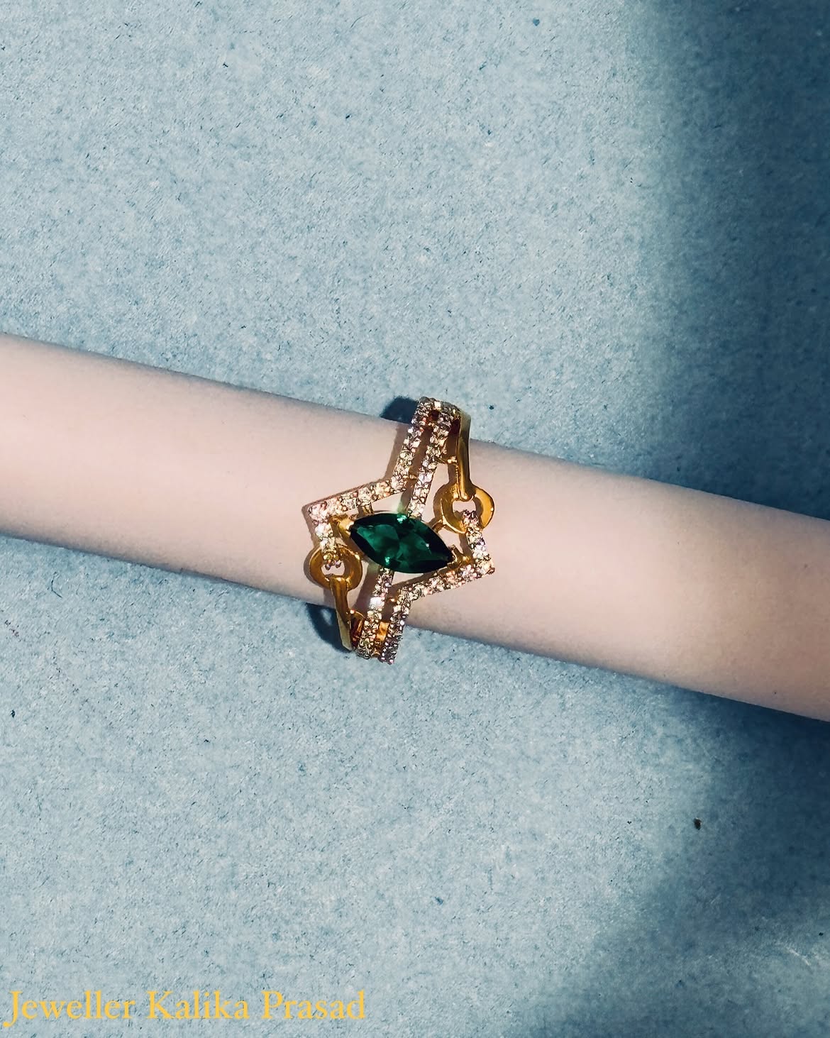 Gold bracelet with a striking green marquise stone