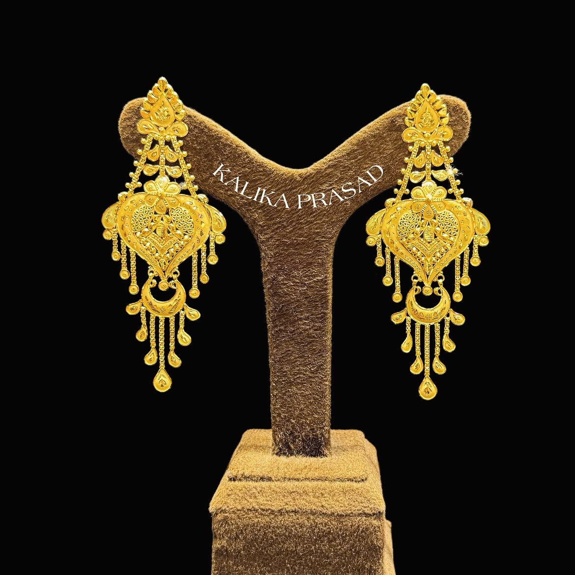 Heart-shaped gold chandbali earrings with detailed work